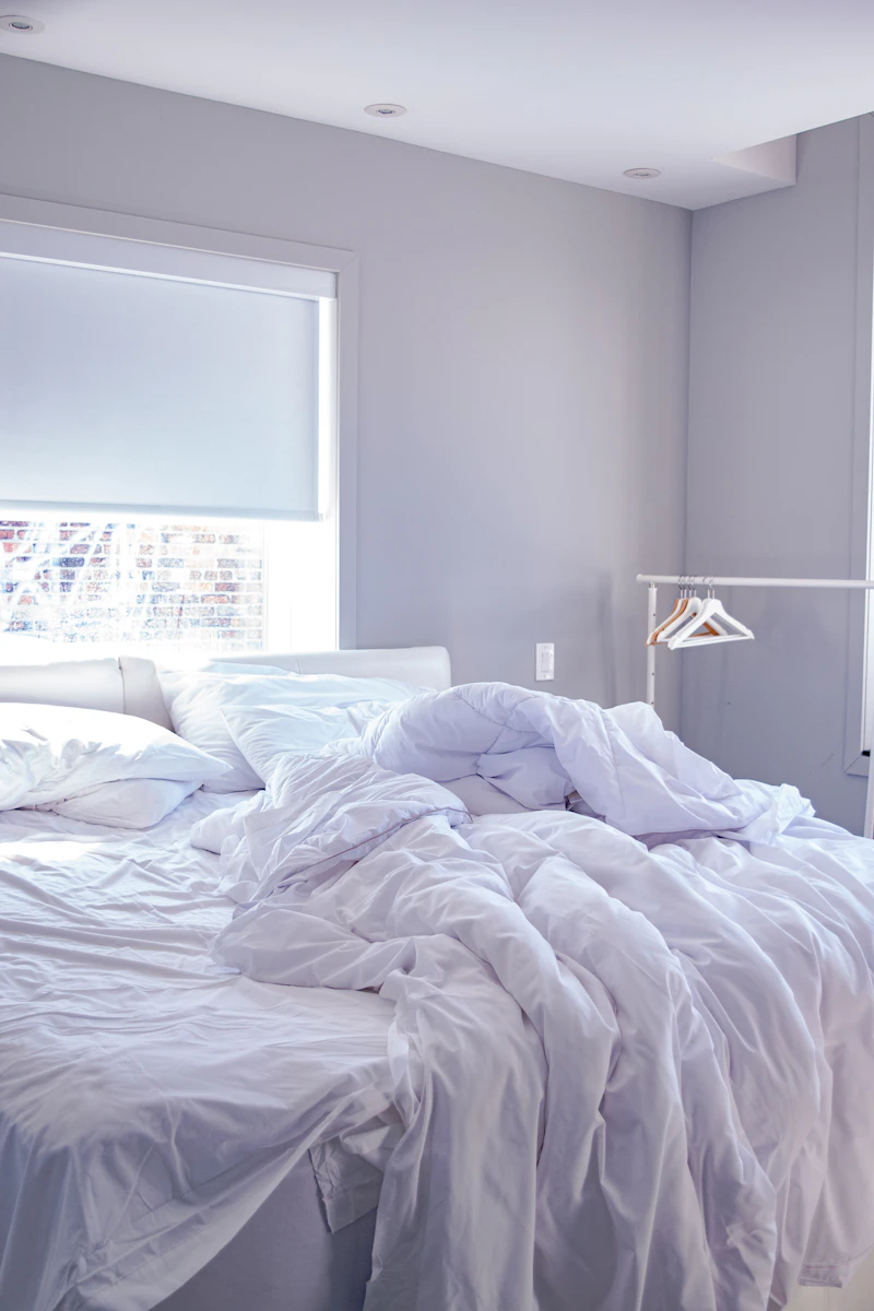 Crisp white hotel linens professionally arranged on a king bed