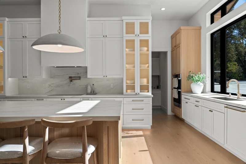 Ultra-clean minimalist kitchen with sage green cabinets